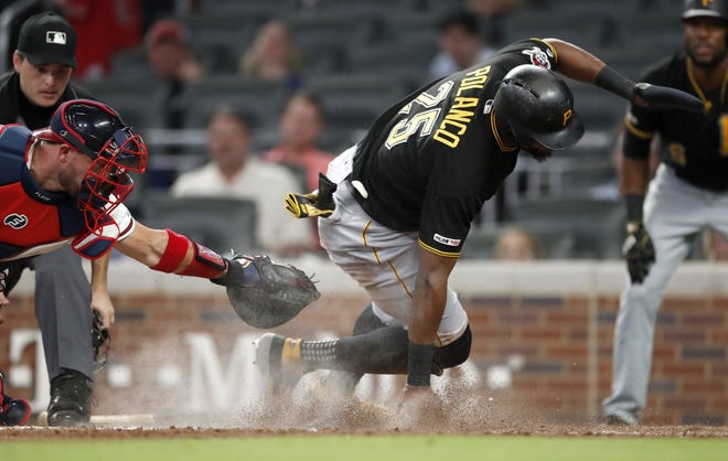 Pittsburgh Pirates' Gregory Polanco scores past the tag of Atlanta catcher Tyler Flowers on a Corey Dickerson sacrifice fly during the sixth inning Wednesday, in Atlanta. [John Bazemore/Associated Press]