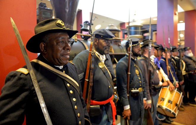 FILE - In this June 20, 2014, file photo, Civil War re-enactors Lt. James Hayes, from left, Samuel Stephenson and Marvin-Alonzo Greer participate in a Juneteenth celebration at the Atlanta Cyclorama and Civil War Museum in Atlanta. Juneteenth celebration started with the freed slaves of Galveston, Texas. Although the Emancipation Proclamation freed the slaves in the South in 1863, it could not be enforced in many places until after the end of the Civil War in 1865. (Kent D. Johnson/Atlanta Journal-Constitution via AP, File)