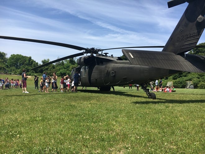 Students from Manomet Elementary School tour the Blackhawk helicopter that landed at their school Wednesday for Military Appreciation Day. [Wicked Local photo/Rich Harbert]