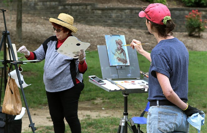 Martha Manco, right, paints a portrait of Brenda Bostian as she works on her artwork in Lineberger Park Wednesday morning. They are part of a group of women who meet once a week to paint at different locations around the county. [JOHN CLARK/THE GASTON GAZETTE]