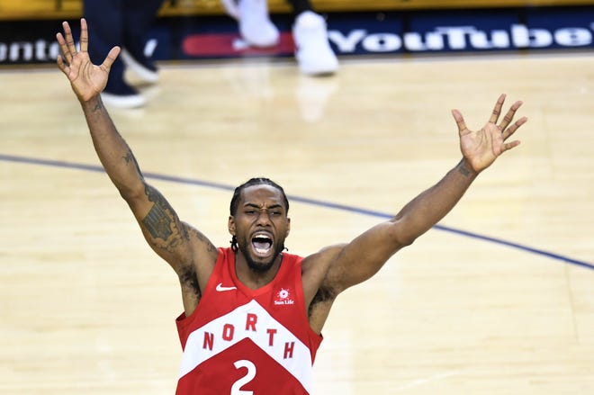 Toronto Raptors star Kawhi Leonard (2) celebrates after the buzzer of a 114-110 Game 6 victory over the Golden State Warriors to win the NBA Finals on Thursday in Oakland, Calif. It is the first championship for the Canadian franchise. [Frank Gunn/The Canadian Press via AP]