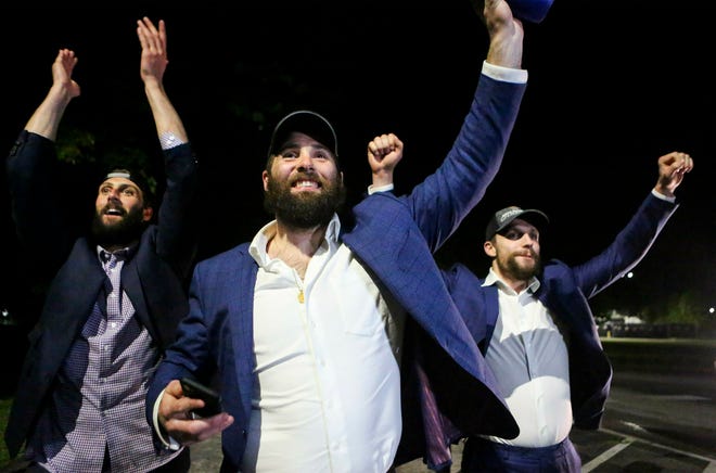 St. Louis Blues NHL hockey players Robert Bortuzo, left, Pat Maroon, center, and David Perron greet fans after arriving at the airport in St. Louis early Thursday, June 13, 2019. The Blues defeated the Boston Bruins 4-1 in Game 7 of the Stanley Cup finals to win their first NHL championship Wednesday night in Boston. (Colter Peterson/St. Louis Post-Dispatch via AP)