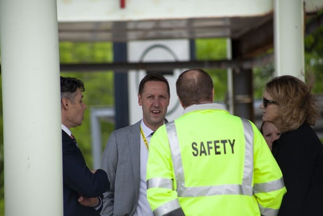 MBTA General Manager Steve Poftak, center, and deputy GM Jeff Gonneville, left, huddled with crews Friday at the JFK/UMass Station, ahead of a press conference to discuss their investigation into Tuesday's Red Line derailment. [State House News Service Photo / Chris Lisinski]