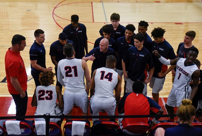 Oxbridge Academy basketball Brandon Strassburger, speaking to the team before the first half of the Class 5A regional semifinal against Coral Springs Charter in West Palm Beach last February, led the ThunderWolves to three straight district titles. [ANDRES LEIVA/palmbeachpost.com]