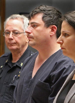 Allen Hanson, center, of East Providence, at his arraignment in 2017. [Journal files]
