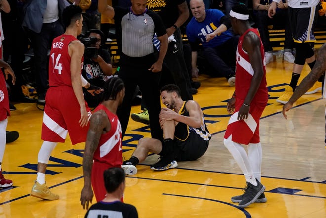 Golden State Warriors guard Klay Thompson reacts after being injured during the second half of Game 6 of the NBA Finals onThursday. Thompson suffered a torn ACL in his left knee. [AP Photo/Tony Avelar]