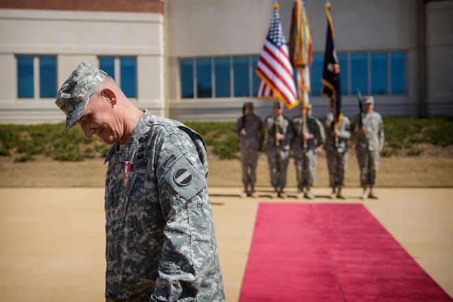 Gen. David Rodriguez smiles as he walks back to his seat after relinquishing his command of Forces Command on March 15, 2013, during Forces Command's Relinquishment of Command ceremony on Fort Bragg. [Andrew Craft/The Fayetteville Observer]