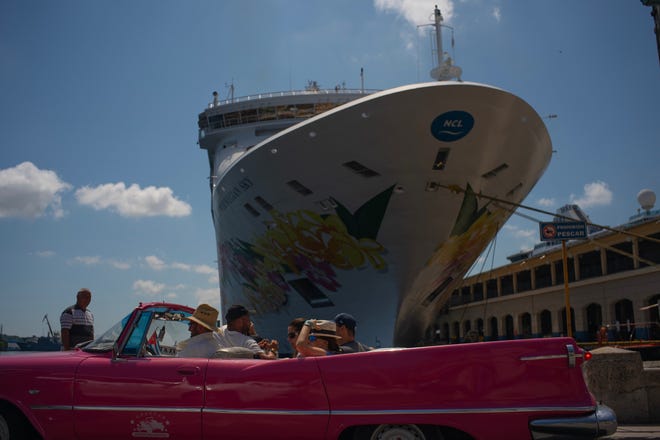 Tourists who have just disembarked from a cruise ship tour Havana, Cuba, aboard a vintage American convertible on June 4. The Trump administration has imposed major new travel restrictions on visits to Cuba by U.S. citizens, banning stops by cruise ships and ending a heavily used form of educational travel as it seeks to further isolate the communist government. [AP Photo/Ramon Espinosa]