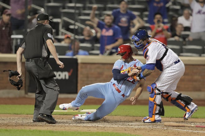 St. Louis Cardinals' Jack Flaherty, center, is tagged out by New York Mets catcher Wilson Ramos for the final out of a baseball game Saturday in New York. The Mets won 8-7. [Julio Cortez/The Associated Press]