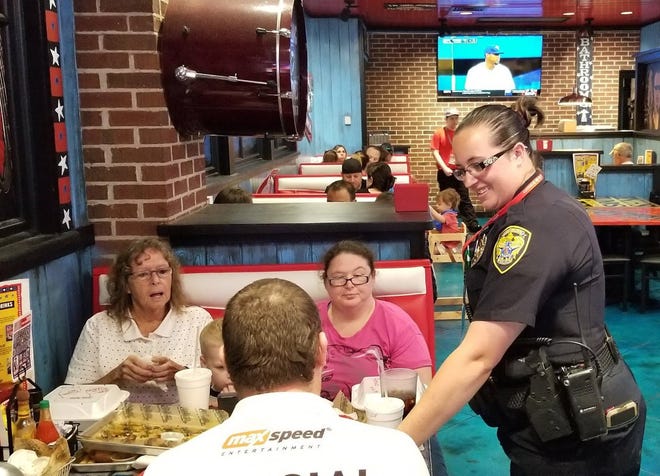 Leesburg police officers served food and chatted with guests during the Tip-a-Cop fundraiser at Mojo Grill and Catering Co. in Leesburg. [Leesburg Police Department/Facebook]