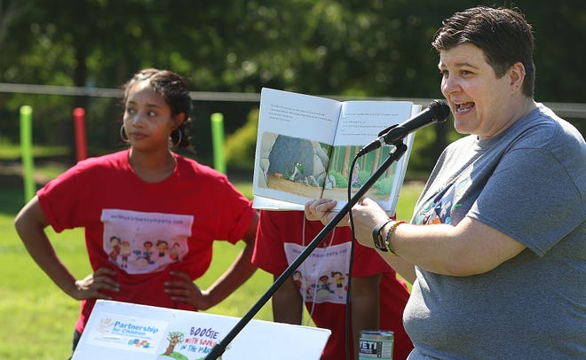 Gaston County librarian Debra Livingston reads from "Not Your Typical Dragon" by Dan Bar-el during the "Boogie with Books" event held Saturday, June 15, 2019, at Lineberger Park. [Mike Hensdill/The Gaston Gazette]