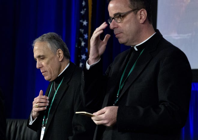 Cardinal Daniel DiNardo, left, of the Archdiocese of Galveston-Houston, president of the United States Conference of Catholic Bishops accompanied by Rev. J. Brian Bransfield, participates in a morning prayer, during the United States Conference of Catholic Bishops (USCCB), 2019 Spring meetings in Baltimore, Tuesday, Jun 11, 2019. (AP Photo/Jose Luis Magana)