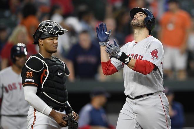 Boston Red Sox DH J.D. Martinez, right, celebrates his two-run home run during the fourth inning of a baseball game next to Baltimore Orioles catcher Pedro Severino, left, on Friday in Baltimore. (AP Photo/Nick Wass)