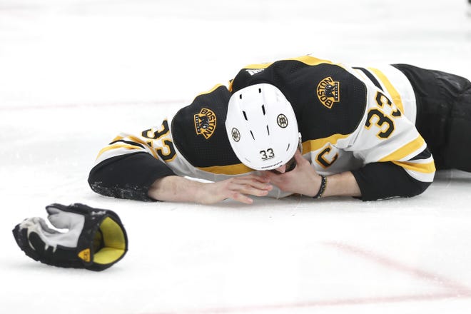 Boston Bruins defenseman Zdeno Chara lies on the ice after getting hit in the face with the puck during the second period of Game 4 of the Stanley Cup Final on June 3, 2019, in St. Louis. Chara had "multiple fractures" in his jaw. [AP File Photo/Jeff Roberson]