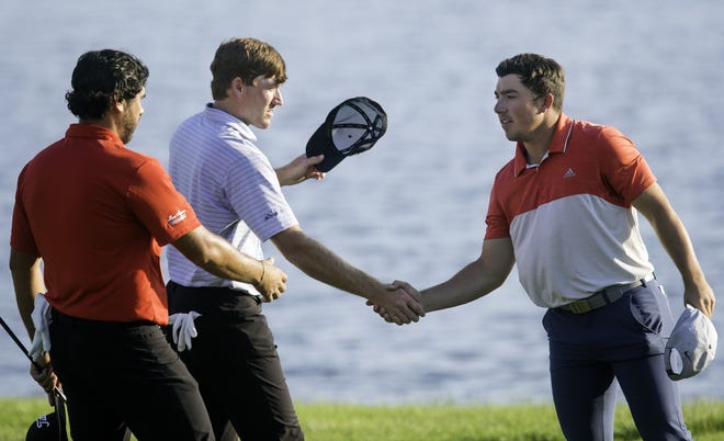 Nelson Ledesma, left, and Robby Shelton shake hands with JD Dornes after they finished during the third round of the Web.com Tour's Lincoln Land Championship presented by LRS at Panther Creek Country Club on Saturday. Shelton shot 10 under and is tied for first. [Ted Schurter/The State Journal-Register]