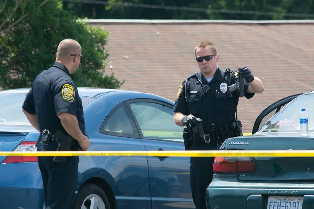 HOMICIDE INVESTIGATION — Asheboro Police officers work the scene where the body of a teen who had been shot was discovered Sunday morning. (Scott Pelkey / Special to The Courier-Tribune)