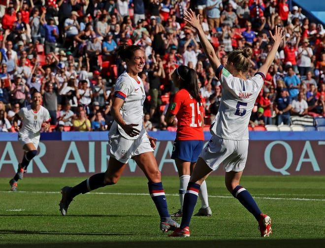 Carli Lloyd, left, celebrates with U.S. teammate Morgan Brian after scoring their side's third goal during the Women's World Cup Group F soccer match between United States and Chile at Parc des Princes in Paris on Sunday. The U.S. won, 3-0. [Photo by AP]