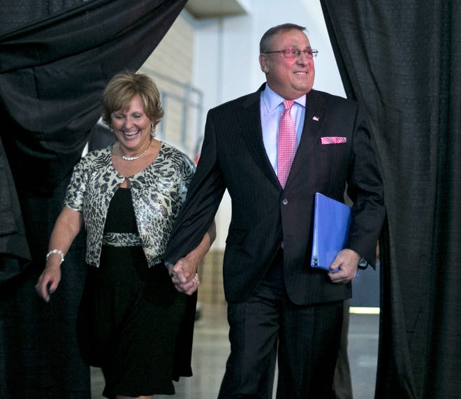 Maine Gov. Paul LePage and first lady Ann LePage arriving at the Maine Republican Convention, in Bangor, Maine, in 2014. Former Republican Gov. LePage's wife won't be the only one in their family spending the summer working at a restaurant. LePage will be joining her as a bartender. McSeagulls Restaurant owner Jeff Stoddard said he hasn't finalized the former governor's schedule but expects him to be tending bar for the entire summer in Boothbay Harbor. The governor's wife, Ann, will be working there again as a server. [AP Photo/Robert F. Bukaty, File]