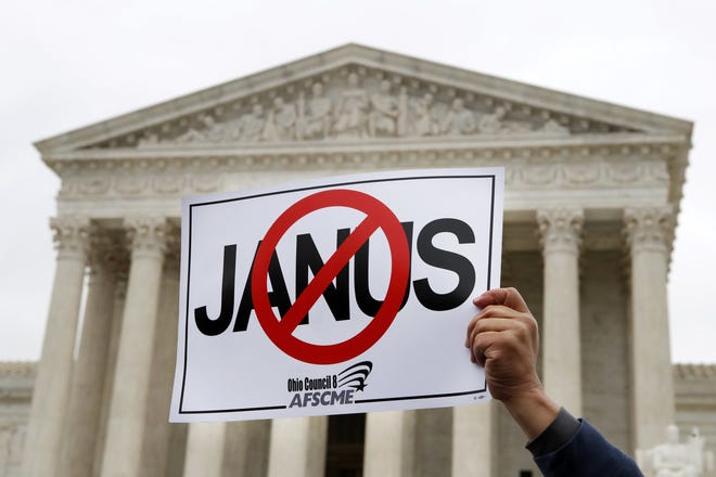 A pro-union demonstrator holds up a sign outside the U.S. Supreme Court in 2018. In a case known as Janus v. AFSCME, the court, in a setback for organized labor, ruled last year that states can't force government workers to pay union fees. [AP Photo / Jacquelyn Martin]