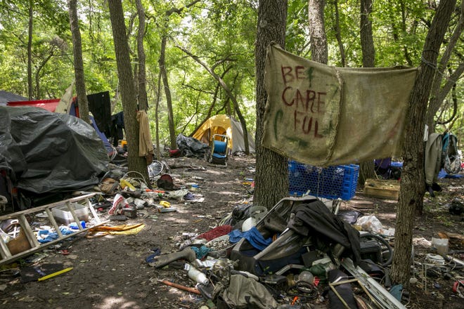 A homeless camp in the woods near East Ben White Boulevard and Burleson Road on May 9. [JAY JANNER/AMERICAN-STATESMAN]