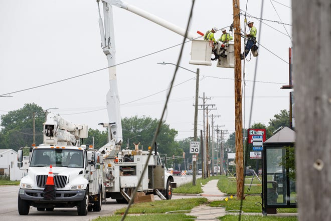 Utility lines lay across the ground as crews from CWLP work to replace a utility pole struck by a Dodge Journey traveling east on Old Rochester Road around 5 a.m., Monday, June 17, 2019, in Springfield, Ill. The accident caused a power outage to the area and shut down South Grand Avenue for most of the day. The driver of the vehicle and three other occupants of the vehicle were transported to Memorial Medical Center and the driver was cited for driving under the influence and failure to reduce speed to avoid an accident. [Justin L. Fowler/The State Journal-Register]
