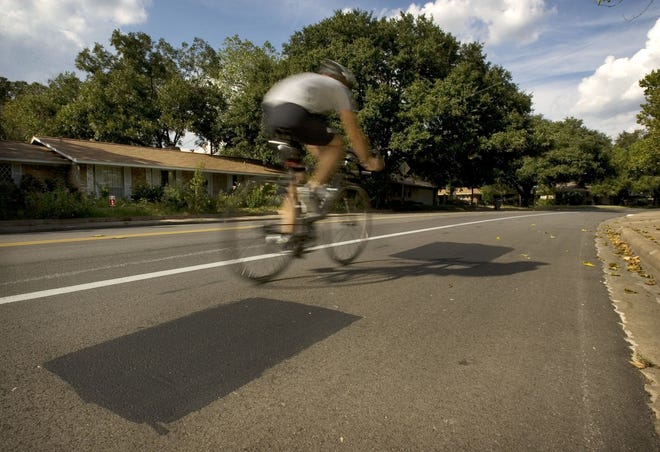 A cyclist rides past a spot where bike lane markings have been removed in the 7200 block of Shoal Creek Boulevard. On Tuesday, the Austin Transportation Department announced it will build protected bike lanes on Shoal Creek Boulevard between 38th Street and U.S. 183. [JAY JANNER/AMERICAN-STATESMAN]