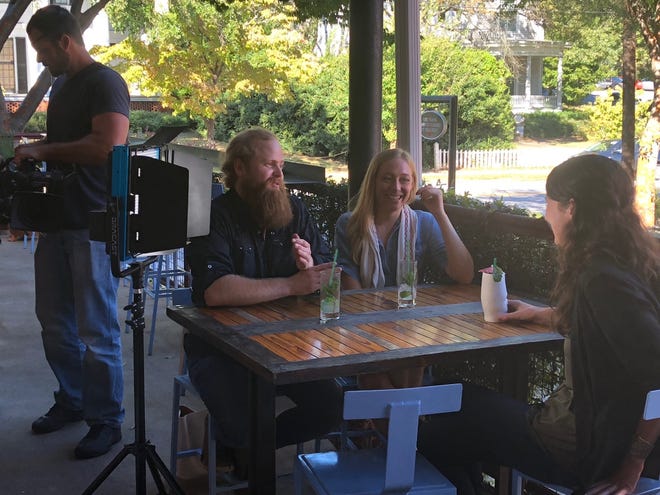 Heather Tenney talking to homebuyers Thomas Johnson and Cara Beckom during filming for an episode of House Hunters on HGTV. [Contributed]
