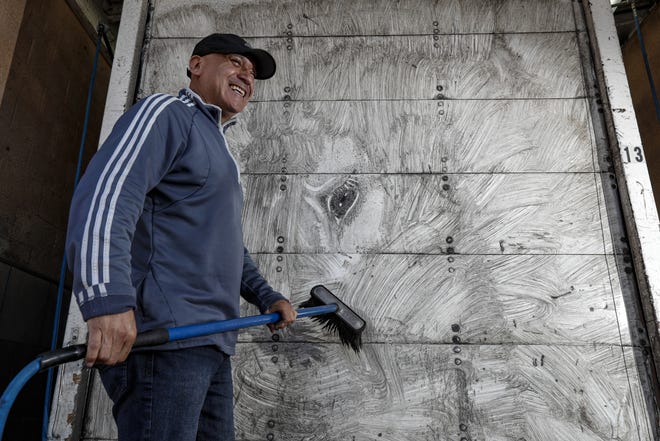 Arnulfo Gonzalez washes artwork drawn by him from his truck at a wash place in Norwalk, Calif., on May 29, 2019. Gonzalez, 48, is a truck driver who "paints" the back of his truck every week using the dirt and grime gathered from his trailer, then drives around Southern California with the artwork as he carries loads of cargo. (Irfan Khan/Los Angeles Times/TNS)