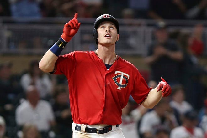 Minnesota's Max Kepler points up in celebration on home base after hitting a solo home run in the 13th inning. [The Associated Press]