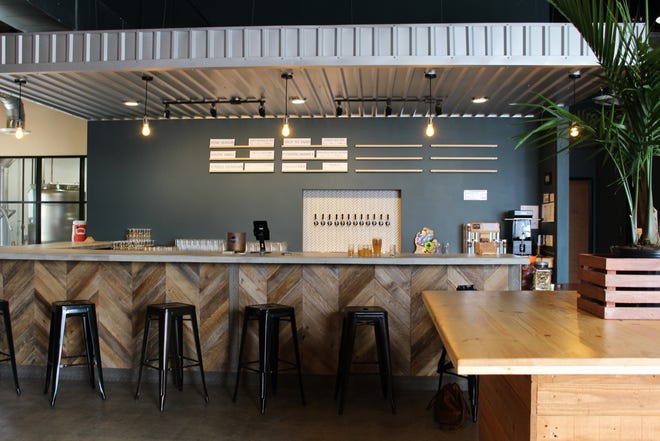 Nomadic Beerworks' taproom features reclaimed elements. For example, the wood of the bar came from a cedar fence in South Austin. [Arianna Auber / AMERICAN-STATESMAN]