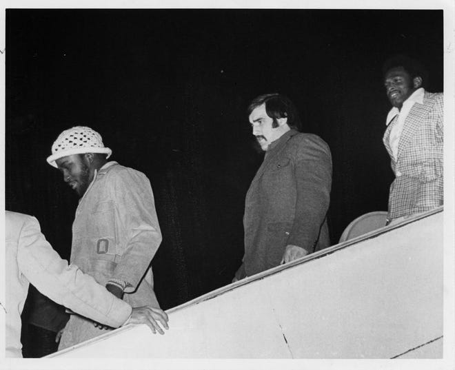 Ohio State University football players return from the Rose Bowl. From left are: Neal Colzie, Arnie Jones and Archie Griffin. January 3, 1974.