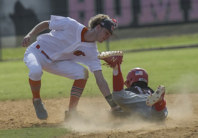 Mount Dora's Brody Holtman (8) tries to tag out Tavares' Lock McDonald (19) at a Class 5A-District 6 playoff game on May 7 in Bushnell. The two teams will be in different districts next season. [PAUL RYAN / CORRESPONDENT]