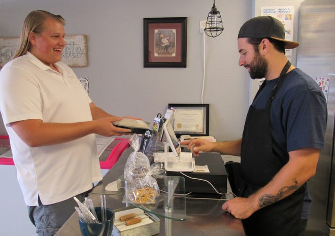 With specific requirements for his meals, Jon Paul picks up a vegan Baked Falafel from Joe Soltes, co-owner of Clean Eats Kitchen LLC in Palm Coast, located in City Market Place. June 12, 2019 [News-Tribune/Danielle Anderson]