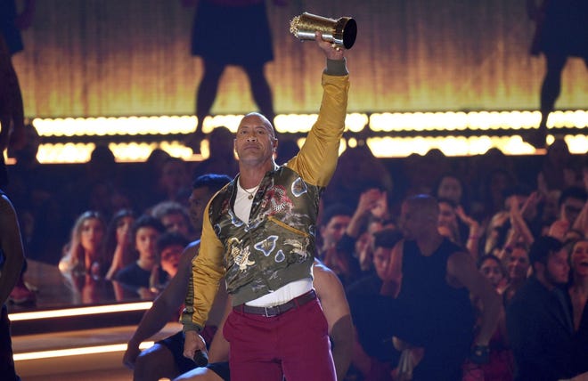 Dwayne Johnson, also known as The Rock, accepts the generation award at the MTV Movie and TV Awards June 15 at the Barker Hangar in Santa Monica, Calif. [The Associated Press]
