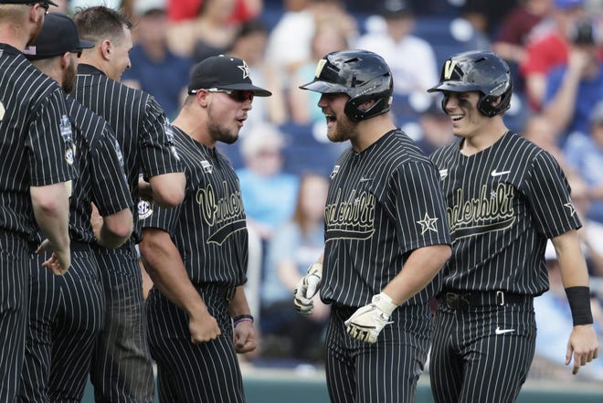 Vanderbilt's Stephen Scott, second right, celebrates with teammates his three-run home run in the fifth inning of a College World Series game against Mississippi State in Omaha, Neb., on Wednesday. [Nati Harnik/The Associated Press]