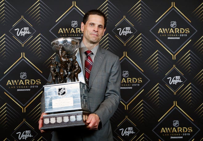 Don Sweeney of the Boston Bruins poses with the General Manager of the Year Award after winning the award at the NHL Awards, Wednesday, June 19, 2019, in Las Vegas. (AP Photo/John Locher)