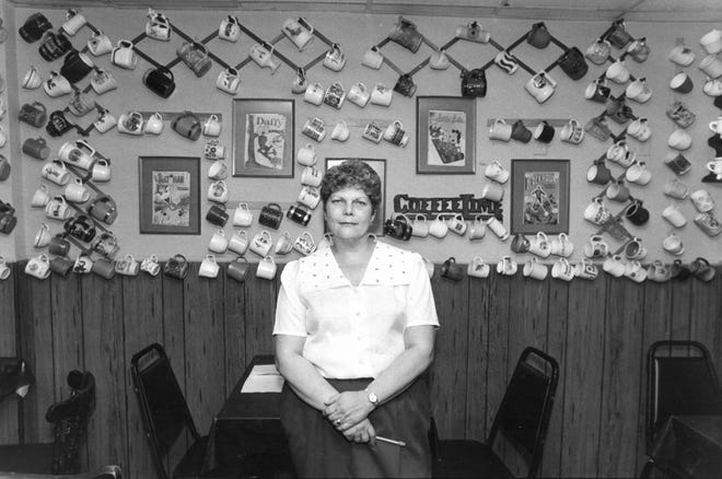 Pat Mandel, owner of W.P. Muggs & Co. at 43 W. Monroe St., is shown with some of the mugs that lined the walls of her restaurant in this 1983 file photo. [John Pemberton/Florida Times-Union]