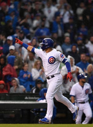 The Chicago Cubs' Willson Contreras celebrates while running the bases after hitting a solo home run during the third inning of the team's baseball game against the Chicago White Sox on Wednesday at Wrigley Field. [AP Photo/Paul Beaty]