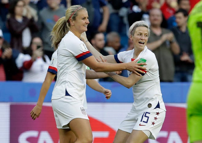 Lindsey Horan (left) is congratulated by teammate Megan Rapinoe after scoring her team's first goal during a 2-0 win by the U.S. over Sweden on Thursday in the Women's World Cup. [AP Photo/Alessandra Tarantino]