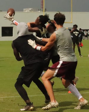 Players from Raines (in black shorts) and Christ's Church (in maroon shorts) battle for a deflected pass during Thursday's Nike 11-On tournament. [Clayton Freeman/GateHouse Florida]