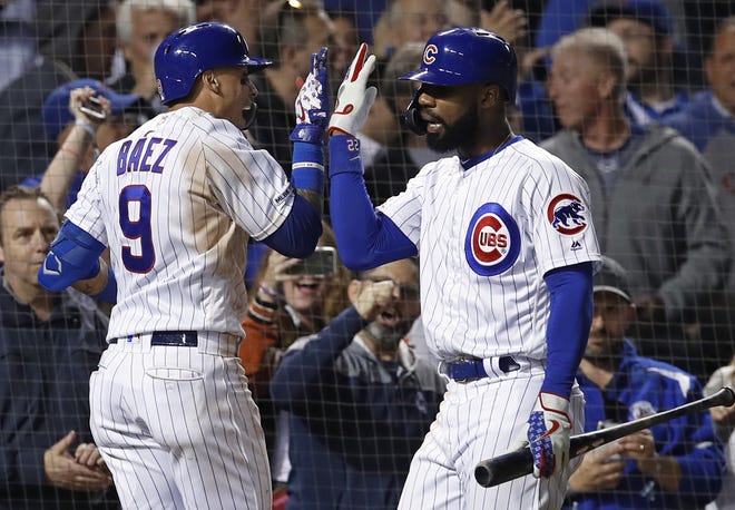 Chicago Cubs shortstop Javier Baez, left, celebrates his home run against the New York Mets with Jason Heyward during the seventh inning Thursday, June 20, 2019, in Chicago. [JIM YOUNG/THE ASSOCIATED PRESS]