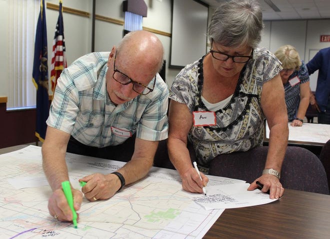 Larry Hermen of Three Rivers marks a potential trail on the map, while his wife, Ann, records their on-road trail priorities.