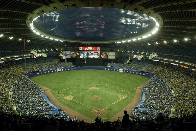 Fans watch a baseball game between the Montreal Expos and Florida Marlins at Olympic Stadium in Montreal on Sept. 29, 2004. The Tampa Bay Rays have received permission from Major League Baseball's executive council to explore a plan that could see the team split its home games between the Tampa Bay area and Montreal, reports said Thursday. [Paul Chiasson/The Canadian Press via AP]