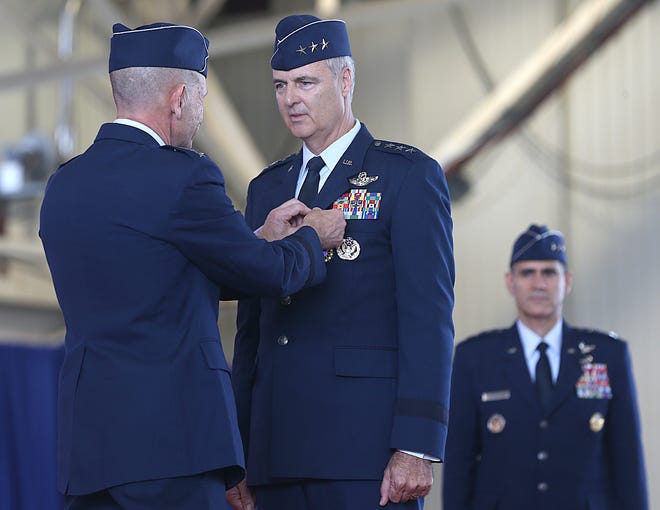 Gen. James Holmes pins a Distinguished Service Medal onto outgoing Cmdr. Lt. Gen. R. Scott Williams during a Change of Command ceremony on June 20, 2019 at Tyndall Air Force Base.[PATTI BLAKE/THE NEWS HERALD]
