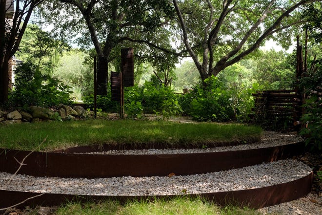 In Northwest Austin, this property by Ecotypes creates circles using steel, stones, grass and a millstone. [Contributed by Sam Bryant, Ecotypes]