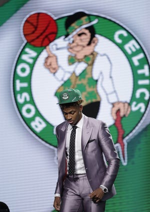 Indiana's Romeo Langford leaves the stage after the Boston Celtics selected him as the 14th pick overall in the NBA Draft on Thursday in New York. (AP Photo/Julio Cortez)