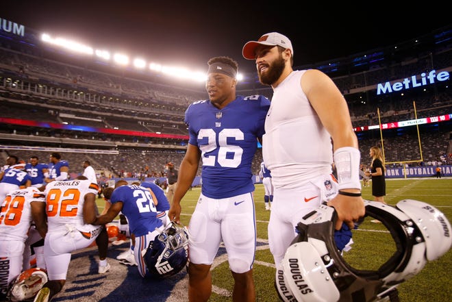 New York Giants running back Saquon Barkley, left, poses for photographs with Cleveland Browns quarterback Baker Mayfield after a preseason NFL football game Thursday, Aug. 9, 2018, in East Rutherford, N.J. The Browns won 20-10. (AP Photo/Adam Hunger)