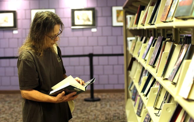 Cathy Waters browses books at Cleveland County Memorial Library. [Brittany Randolph/The Star]