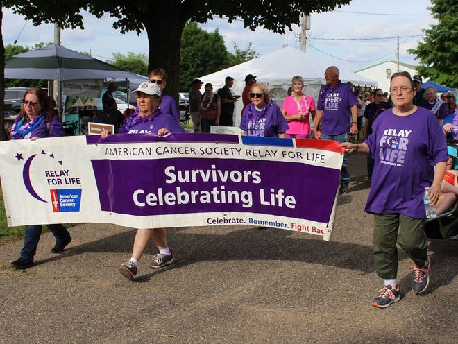 Cancer survivors take a lap around the fairgrounds at “Relay For Life” in Centreville.