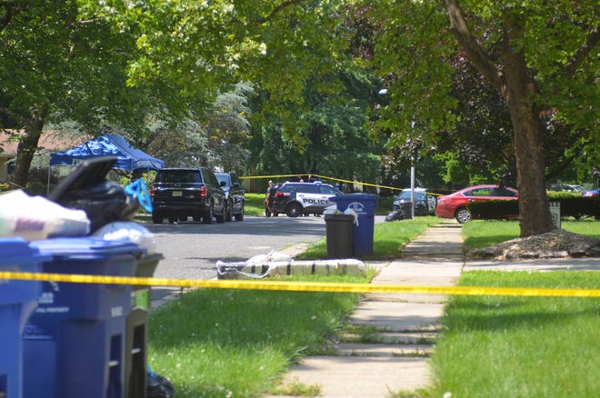 Police investigate a death scene Thursday at 150 Eastbrook Lane in Willingboro. [LISA BROADT/STAFF]